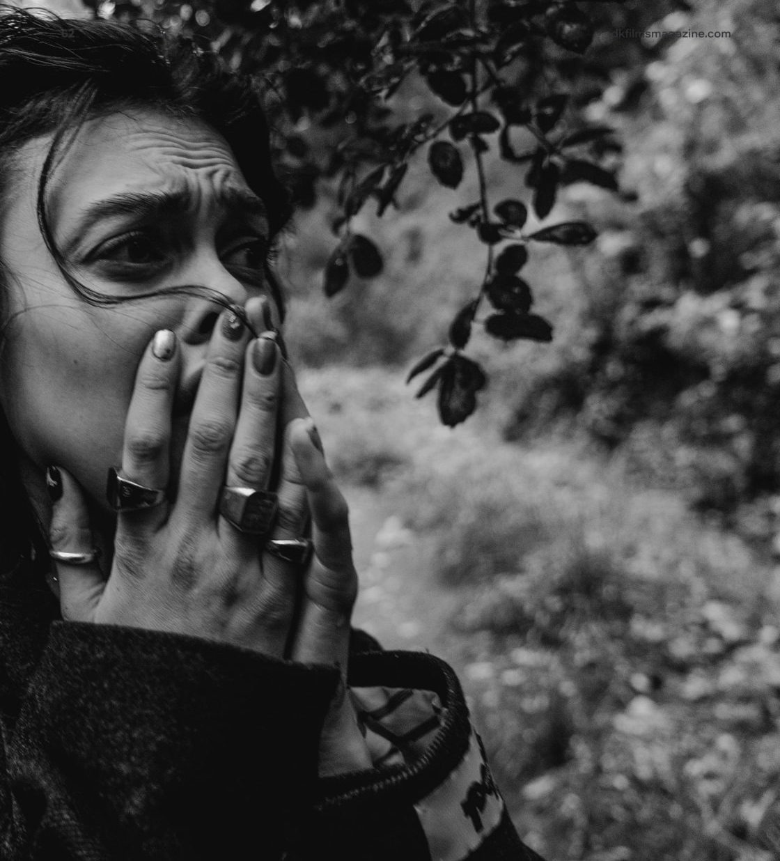 Liza, black and white, hands to her face